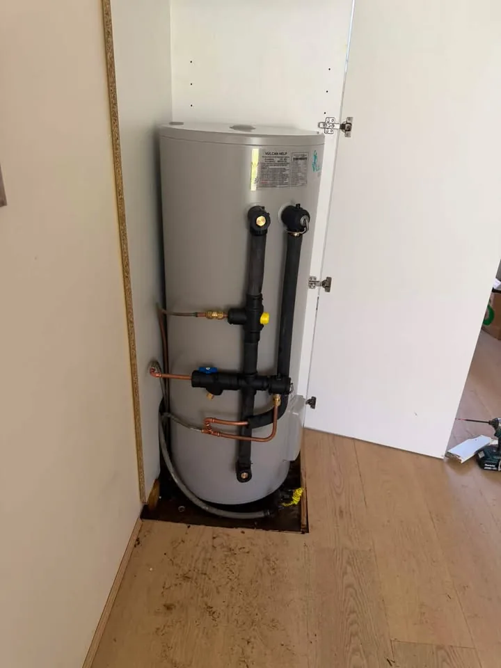 Compact electric hot water unit installed inside a cupboard