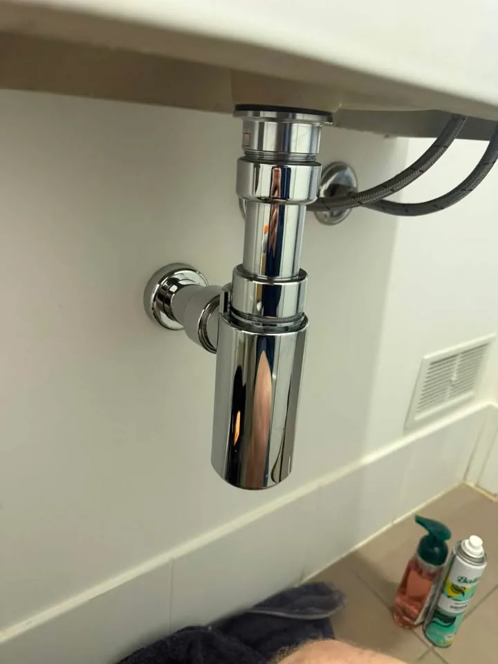 Chrome bottle trap fitted under a basin