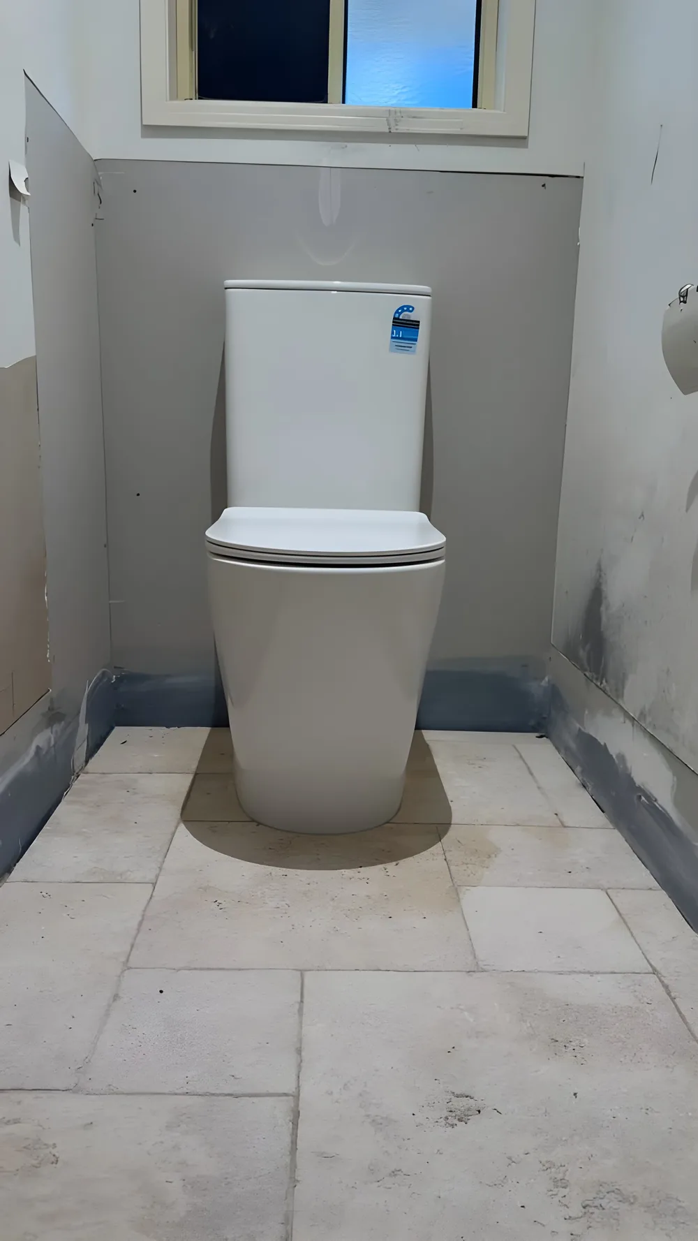 Toilet fit-off in a freshly tiled bathroom