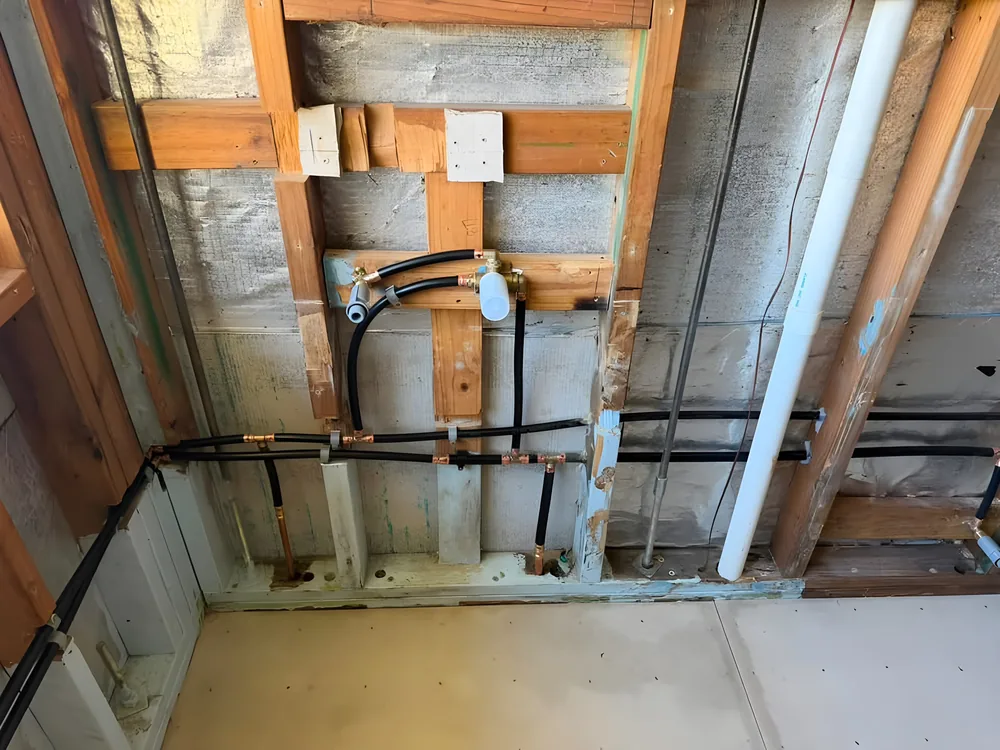 Bathroom rough-in with new water lines run through timber framing